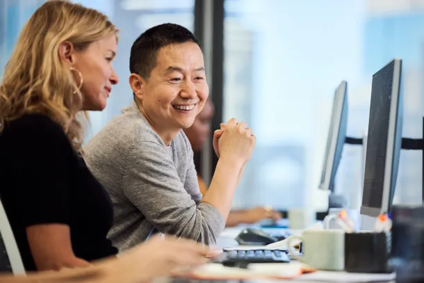 Two office workers at a computer