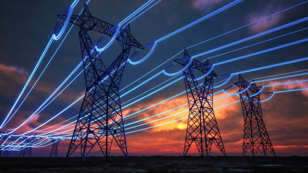 High-voltage power lines against a sunset, with glowing blue energy lines.